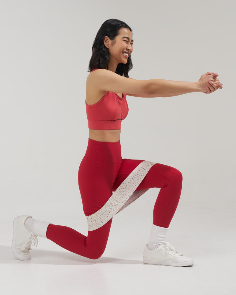 laughing girl doing a lunge with a medium terrazzo resistance resistance band