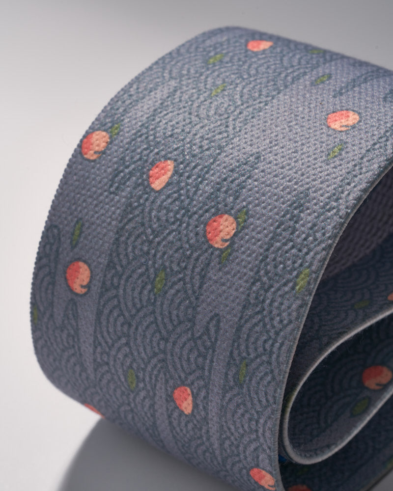 rolled up blue resistance band with Japanese water and peach design