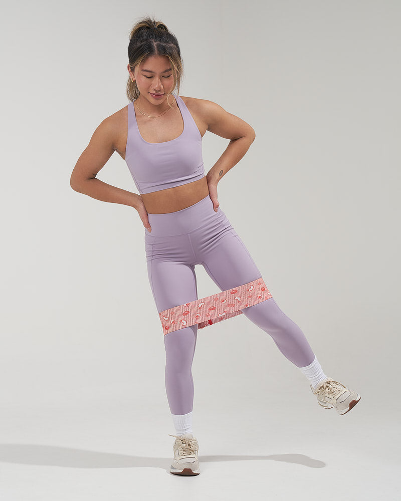 girl standing and doing a hip abductor exercise with a cute booty band