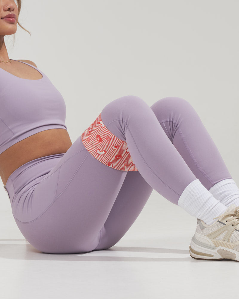 girl doing a sitting hip abductor exercise with a cute fabric resistance band