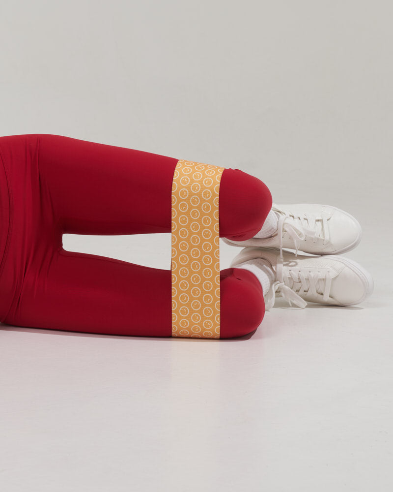 close up of a hip abductor exercise demonstrated with a egg yolk yellow colored fitness band