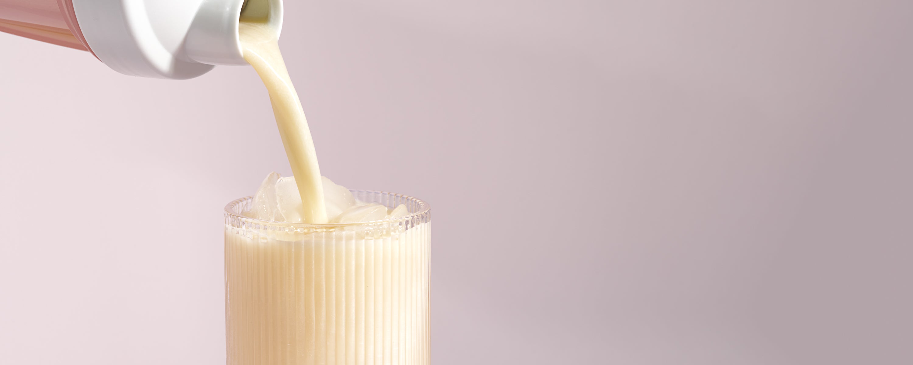 momo asian yogurt flavored whey protein being poured into a cup