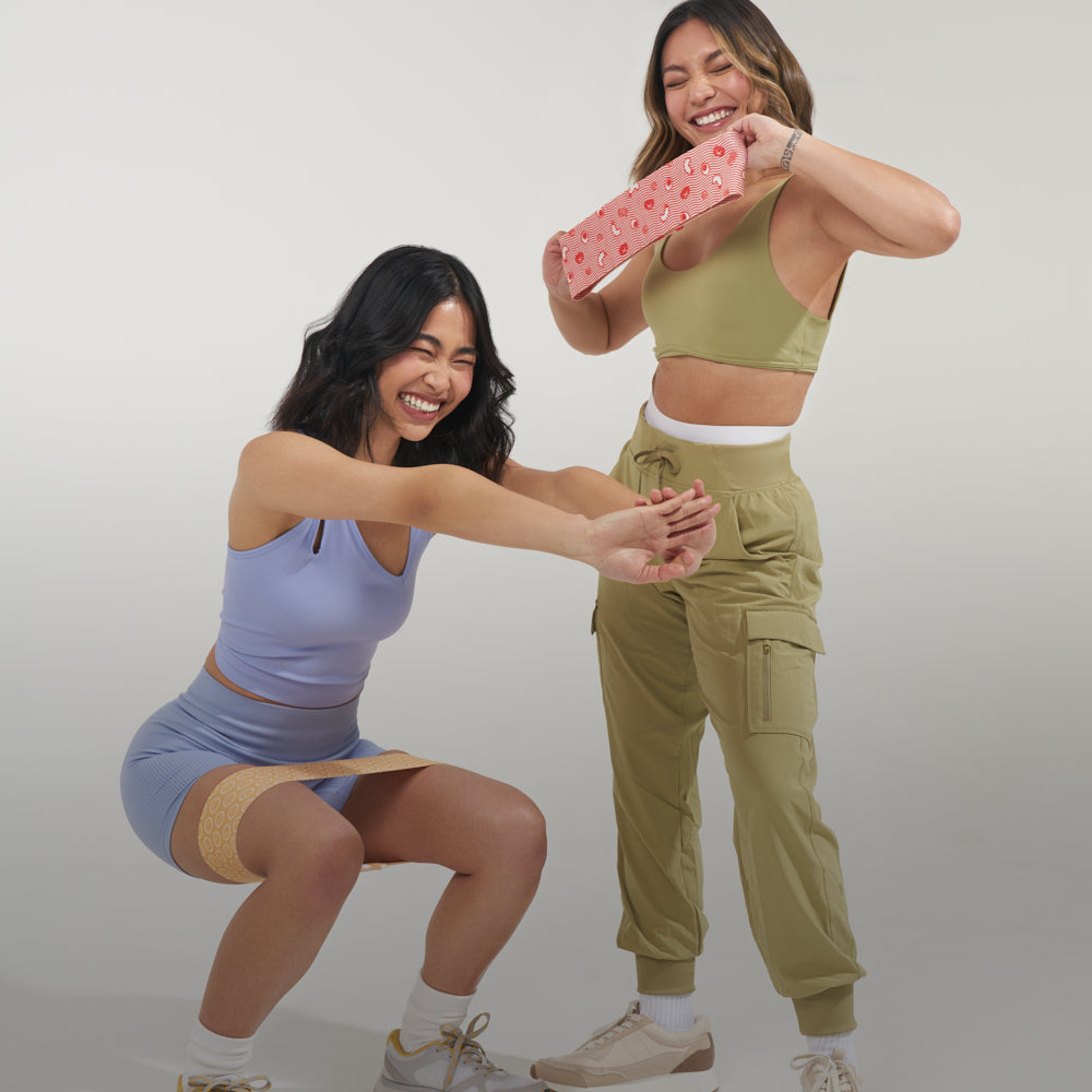 Two asian girls exercising with cute fabric resistance bands