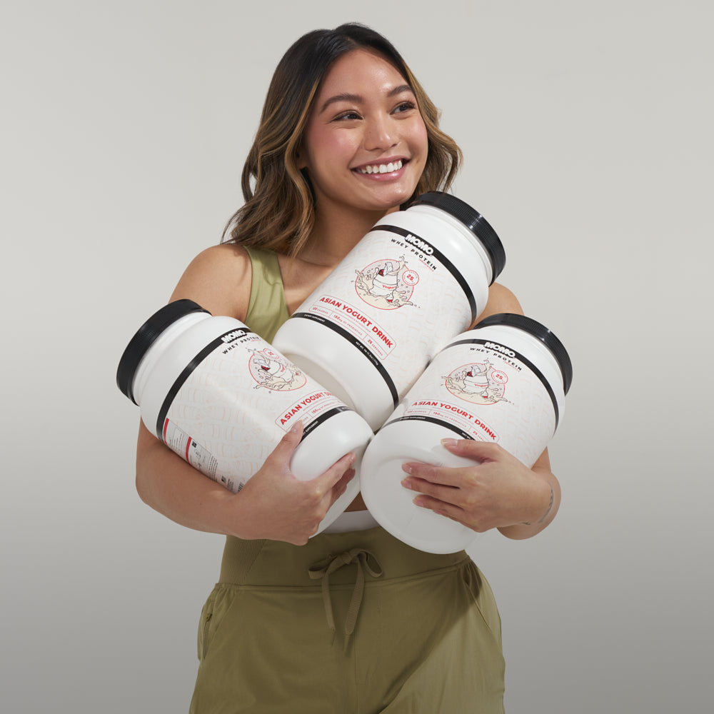 Asian girl holding 3 tubs of MOMO Asian Yogurt Whey Protein